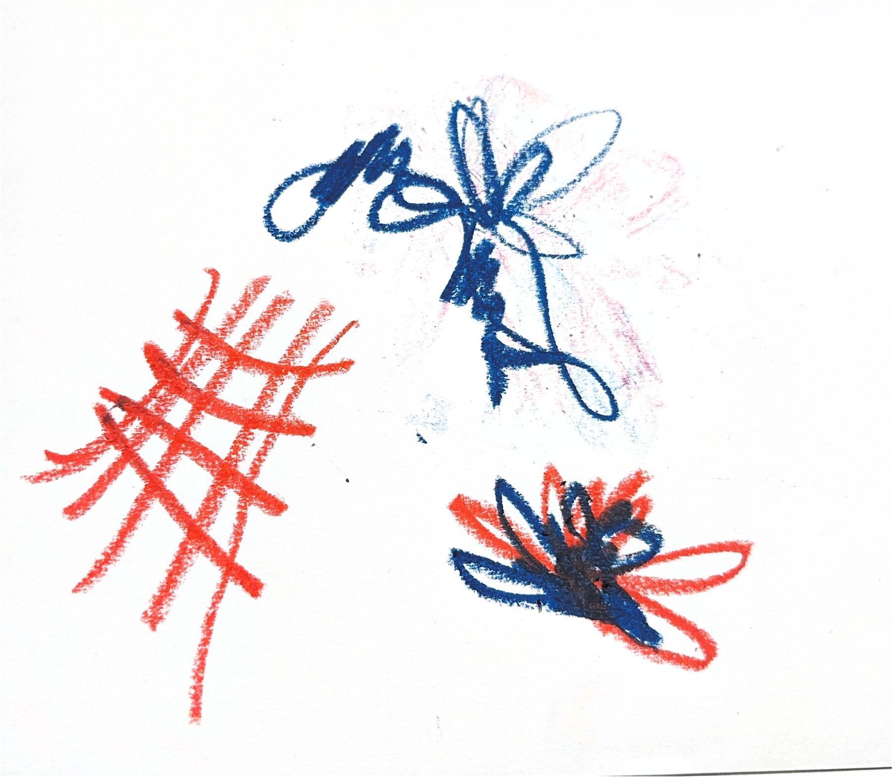 Red and blue crayon marks on white paper