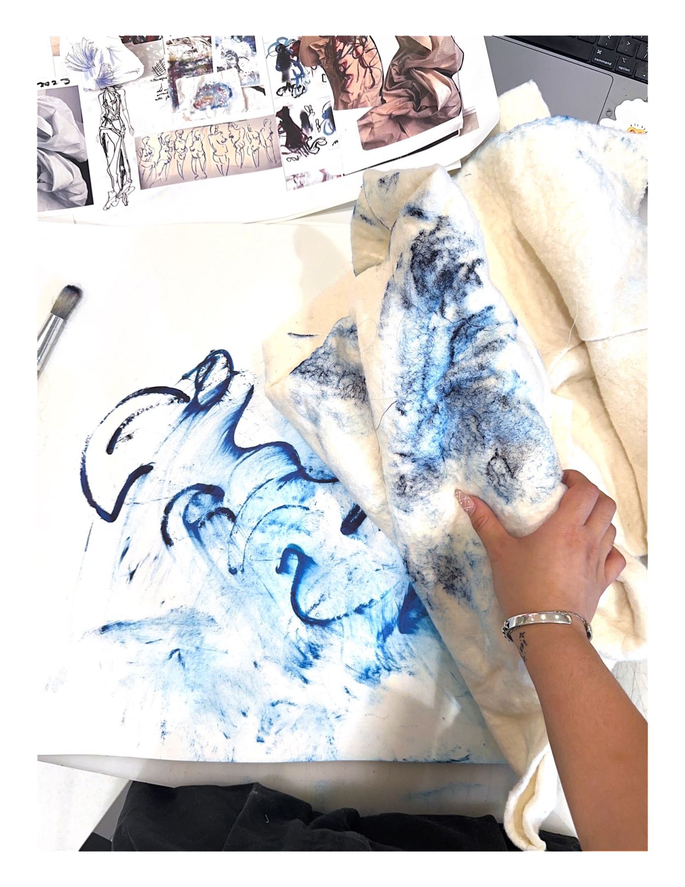 Ianna's hand working blue ink into fabric